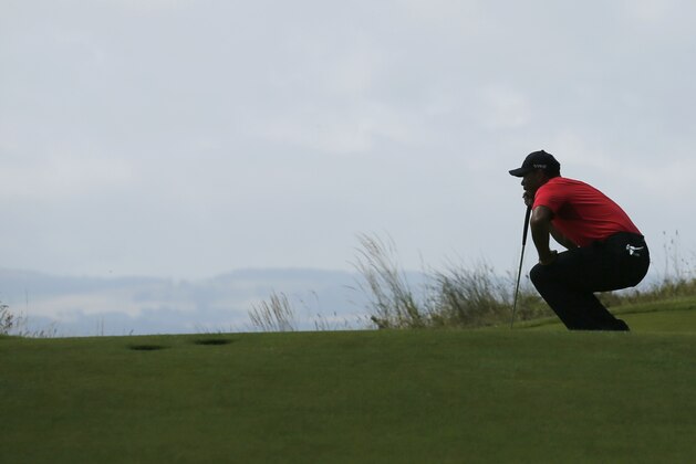 Tiger Woods of the US lines up a putt on the 13th green during the final round of the British Open Golf championship at the Royal Liverpool golf club, Hoylake, England, Sunday July 20, 2014. (AP Photo/Jon Super)