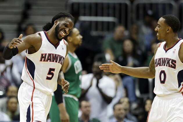 Atlanta Hawks' DeMarre Carroll, left, high-fives teammate Jeff Teague after scoring a basket in the fourth quarter of an NBA basketball game against the Boston Celtics, Wednesday, April 9, 2014, in Atlanta. Atlanta won 105-97. (AP Photo/David Goldman)