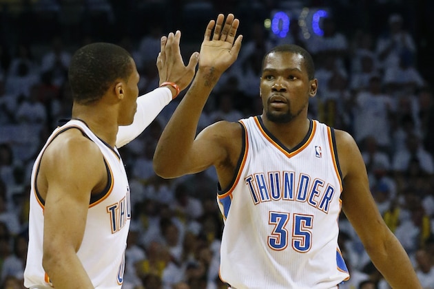 Oklahoma City Thunder's Russell Westbrook, left, and Kevin Durant celebrate during the first half against the San Antonio Spurs in Game 6 of the Western Conference finals NBA basketball playoff series in Oklahoma City, Saturday, May 31, 2014. (AP Photo/Sue Ogrocki)