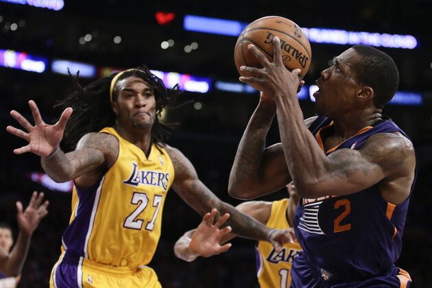Phoenix Suns guard Eric Bledsoe, right, shoots over Los Angeles Lakers center Jordan Hill during the second half of an NBA basketball game in Los Angeles, Tuesday, Dec. 10, 2013. (AP Photo/Chris Carlson)