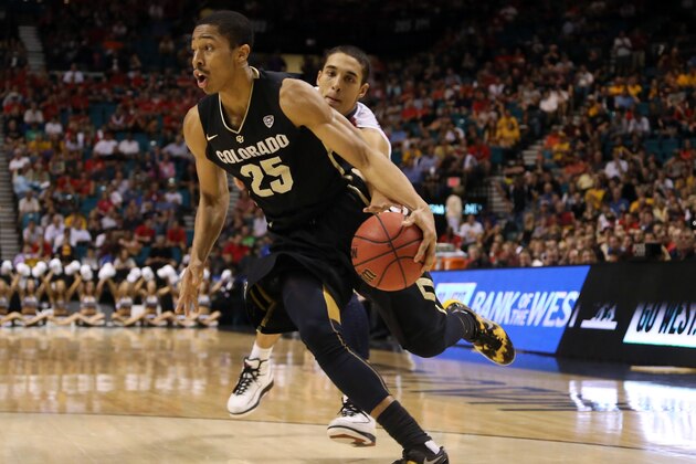 LAS VEGAS, NV - MARCH 14:  Spencer Dinwiddie #25 of the Colorado Buffaloes dries by Nick Johnson #13 of the Arizona Wildcats in the first half during the quarterfinals of the Pac-12 tournament at the MGM Grand Garden Arena on March 14, 2013 in Las Vegas, Nevada.  (Photo by Jeff Gross/Getty Images)