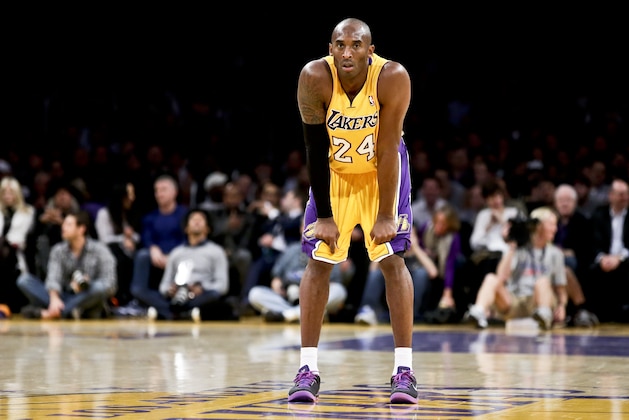 Los Angeles Lakers guard Kobe Bryant watches his team during an NBA basketball game against the Phoenix Suns in Los Angeles, Tuesday, Dec. 10, 2013. (AP Photo/Chris Carlson)