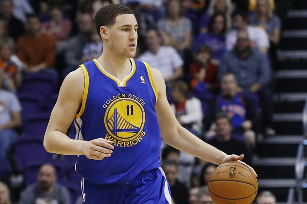 Golden State Warriors' Klay Thompson dribbles the ball against the Phoenix Suns during the first half of an NBA basketball game Saturday, Feb. 8, 2014, in Phoenix.  The Suns defeated the Warriors 122-109. (AP Photo/Ross D. Franklin)