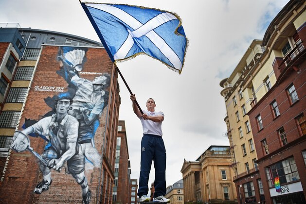 GLASGOW, SCOTLAND - JULY 21:  Euan Burton, multiple World and European medal winning judoka poses with the Scottish Saltire flag on September 21, 2014 in Glasgow,Scotland. Euan has been selected to carry the Scottish flag and lead team Scotland into the Opening Ceremony of the Commonwealth Games, which opens at Celtic Park on Wednesday.  (Photo by Jeff J Mitchell/Getty Images)