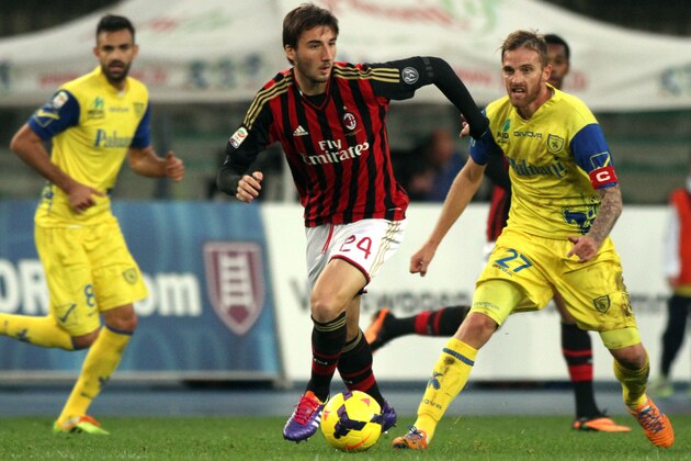AC Milan's Bryan Cristante, center, is challenged by Chievo defender Luca Rigoni, right, during a Serie A soccer match at Bentegodi stadium in Verona, Italy, Sunday, Nov. 10, 2013. (AP Photo/Felice Calabro') AC Milan's Bryan Cristante, center, is challenged by Chievo defender Luca Rigoni, right, during a Serie A soccer match at Bentegodi stadium in Verona, Italy, Sunday, Nov. 10, 2013. (AP Photo/Felice Calabro')