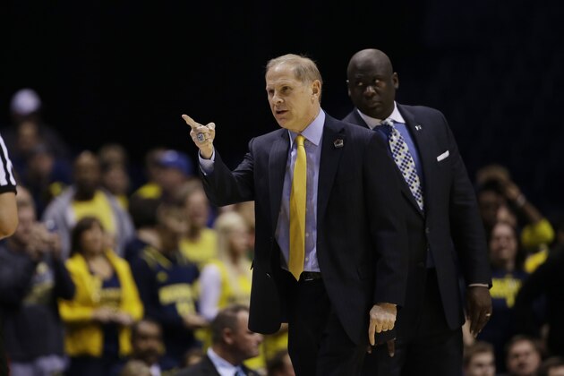 Michigan head coach John Beilein directs his team before an NCAA Midwest Regional semifinal college basketball tournament game against the Tennessee Friday, March 28, 2014, in Indianapolis. (AP Photo/David J. Phillip)