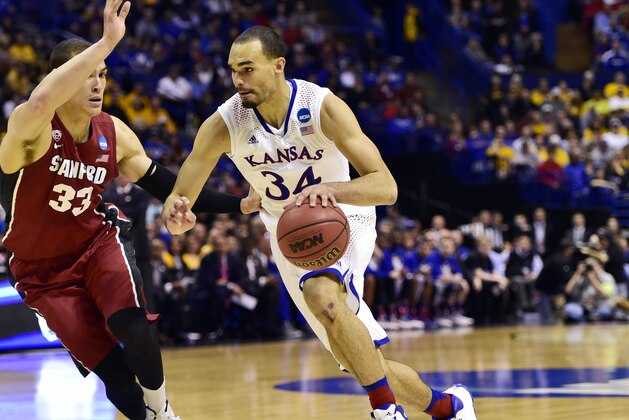 Mar 23, 2014; St. Louis, MO, USA; Kansas Jayhawks forward Perry Ellis (34) drives to the basket defended by Stanford Cardinal forward Dwight Powell (33) during the first half in the third round of the 2014 NCAA Men's Basketball Championship at Scottrade Center. Mandatory Credit: Scott Rovak-USA TODAY Sports