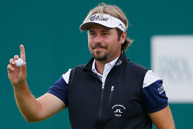 HOYLAKE, ENGLAND - JULY 19:  Victor Dubuisson of France acknowledges the crowd on the 18th green during the third round of The 143rd Open Championship at Royal Liverpool on July 19, 2014 in Hoylake, England.  (Photo by Tom Pennington/Getty Images)