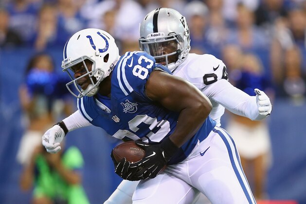 INDIANAPOLIS, IN - SEPTEMBER 08:  Dwayne Allen #83 of the Indianapolis Colts runs for a touchdown while defended by Kevin Burnett #94 of the Oakland Raiders during the Colts 21-17 win at Lucas Oil Stadium on September 8, 2013 in Indianapolis, Indiana.  (Photo by Andy Lyons/Getty Images)