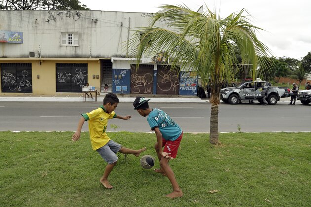 Boys play soccer on the street prior to the group A World Cup soccer match between Brazil and Mexico at the Arena Castelao in Fortaleza, Brazil, Tuesday, June 17, 2014.  (AP Photo/Themba Hadebe)