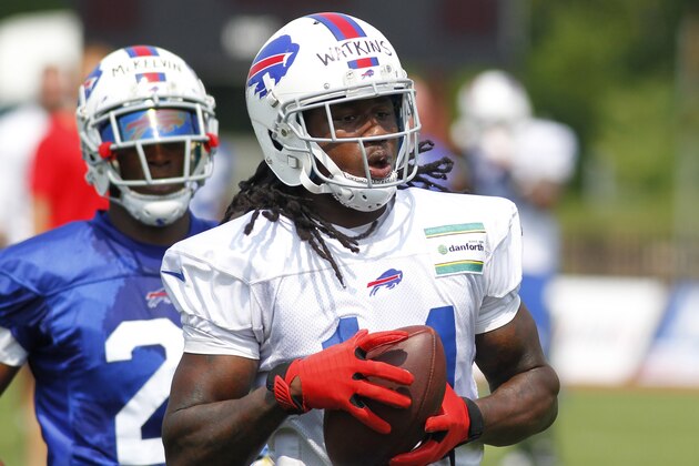 Buffalo Bills wide receiver Sammy Watkins (14) makes a reception against corner back Leodis McKelvin (21) during their NFL football training camp in Pittsford, N.Y., Monday, July 21, 2014. (AP Photo/Bill Wippert)