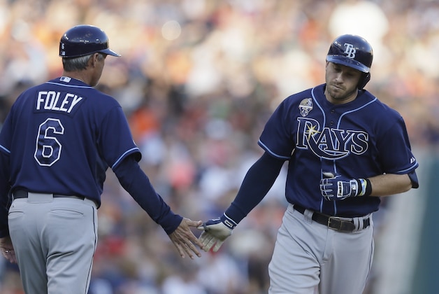 Tampa Bay Rays' Evan Longoria, right, rounds the bases and is congratulated by third base coach Tom Foley after his solo home run during the fourth inning of a baseball game against the Detroit Tigers in Detroit, Friday, July 4, 2014. (AP Photo/Carlos Osorio)