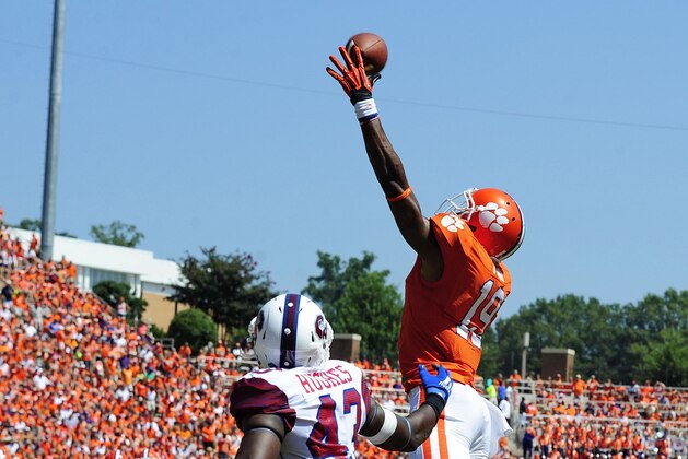 Clemson wide receiver Charone Peake leaps for a pass over South Carolina State's Justin Hughes during the first half  of an NCAA college football game Saturday Aug. 31, 2013 at Memorial Stadium in Clemson, S.C.(AP Photo/ Richard Shiro)