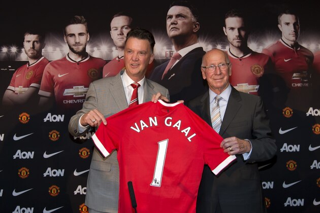 Manchester United's new manager Louis van Gaal, left, poses for pictures with former player Bobby Charlton before a press conference at Old Trafford Stadium, Manchester, England, Thursday July 17, 2014. The new manager takes over after recently guiding Holland to third pace at the 2014 World Cup. (AP Photo/Jon Super)