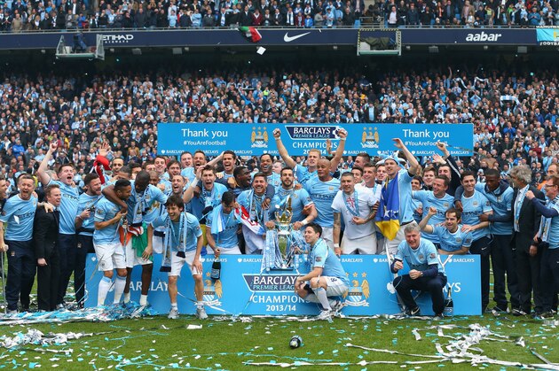 MANCHESTER, ENGLAND - MAY 11:  The Manchester City players celebrate with the Premier League trophy at the end of the Barclays Premier League match between Manchester City and West Ham United at the Etihad Stadium on May 11, 2014 in Manchester, England.  (Photo by Alex Livesey/Getty Images)