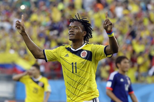 Colombia's Juan Cuadrado celebrates after scoring the opening goal from the penalty spot during the group C World Cup soccer match between Japan and Colombia at the Arena Pantanal in Cuiaba, Brazil, Tuesday, June 24, 2014.  (AP Photo/Kirsty Wigglesworth)