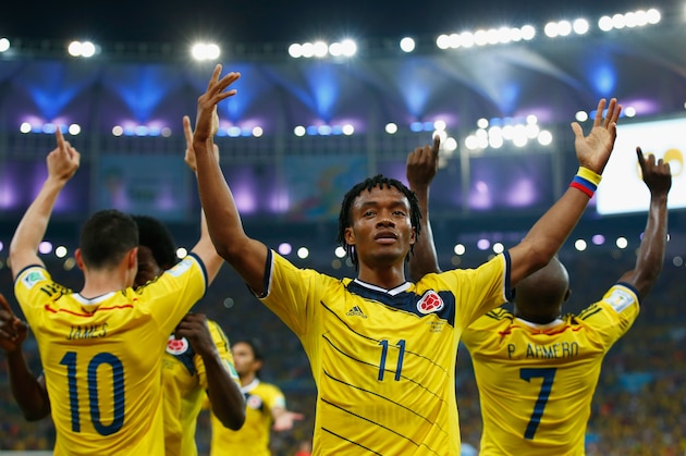RIO DE JANEIRO, BRAZIL - JUNE 28: Juan Guillermo Cuadrado of Colombia celebrates his team's second goal scored by James Rodriguez (L) during the 2014 FIFA World Cup Brazil round of 16 match between Colombia and Uruguay at Maracana on June 28, 2014 in Rio de Janeiro, Brazil.  (Photo by Clive Rose/Getty Images)