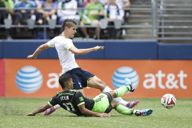 Tottenham Hotspur's Erik Lamela, top, takes a shot as he is tackled by Seattle Sounders' DeAndre Yedlin during the second half of a friendly soccer match in Seattle, Saturday, July 19, 2014. The matched ended in a 3-3 draw. (AP Photo/Stephen Brashear) Tottenham Hotspur's Erik Lamela, top, takes a shot as he is tackled by Seattle Sounders' DeAndre Yedlin during the second half of a friendly soccer match in Seattle, Saturday, July 19, 2014. The matched ended in a 3-3 draw. (AP Photo/Stephen Brashear)