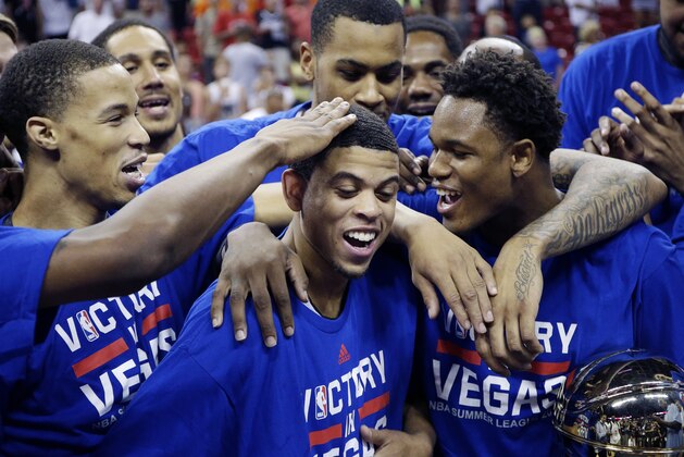 Sacramento Kings' Ray McCallum, center, celebrates after he was named the game MVP for the NBA summer league championship basketball game against the Houston Rockets Monday, July 21, 2014, in Las Vegas. McCallum scored 29 points and made nine rebounds in the game. (AP Photo/John Locher)