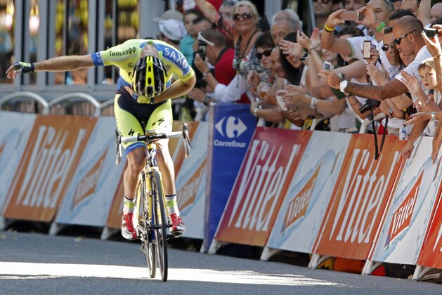 Australia's Michael Rogers bows for cheering spectators as he crosses the finish line to win the sixteenth stage of the Tour de France cycling race over 237.5 kilometers (147.6 miles) with start in Carcassonne and finish in Bagneres-de-Luchon, France, Tuesday, July 22, 2014. (AP Photo/Peter Dejong)