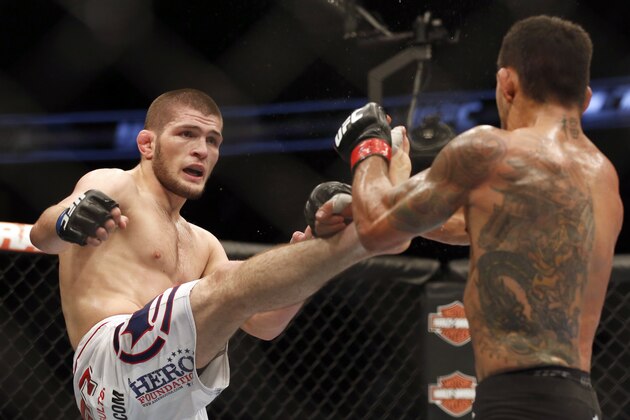 Rafael dos Anjos from Brazil, right and Khabib Nurmagomedov from Russia fight in a mixed martial arts event on Saturday, April 19, 2014, at UFC Fight Night in Orlando Fla.. Nurmagomedov won. (AP Photo/Reinhold Matay)