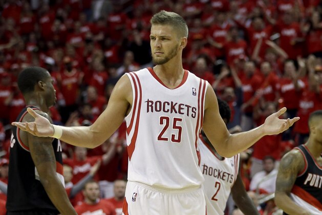 Houston Rockets' Chandler Parsons (25) reacts after Portland Trail Blazers' Robin Lopez hit him on the shoulder after fouling out during overtime in Game 1 of an opening-round NBA basketball playoff series Sunday, April 20, 2014, in Houston. The Trail Blazers won 122-120 in overtime. (AP Photo/David J. Phillip)
