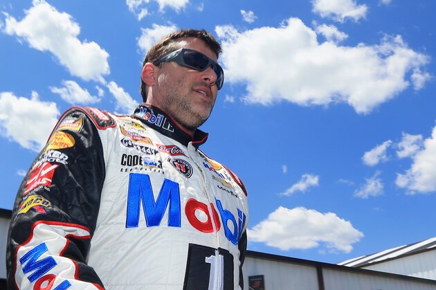 LONG POND, PA - JUNE 07:  Tony Stewart, driver of the #14 Mobil 1/Bass Pro Shops Chevrolet, walks through the garage area during practice for the NASCAR Sprint Cup Series Pocono 400 at Pocono Raceway on June 7, 2014 in Long Pond, Pennsylvania.  (Photo by Daniel Shirey/Getty Images)