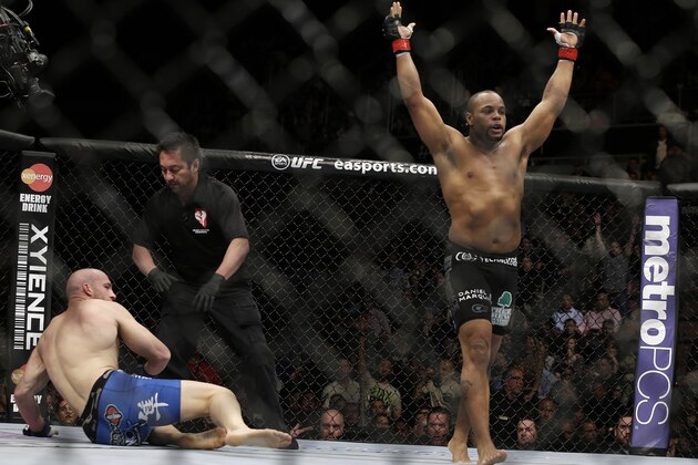 Daniel Cormier, right, reacts as the referee stops his UFC 170 mixed martial arts light heavyweight fight against Patrick Cummins on Saturday, Feb. 22, 2014, in Las Vegas. (AP Photo/Isaac Brekken)