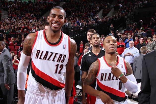 PORTLAND, OR - DECEMBER 21:  Damian Lillard #0 and LaMarcus Aldridge #12 of the Portland Trail Blazers smile after the game against the New Orleans Pelicans on December 21, 2013 at the Moda Center Arena in Portland, Oregon. NOTE TO USER: User expressly acknowledges and agrees that, by downloading and or using this photograph, user is consenting to the terms and conditions of the Getty Images License Agreement. Mandatory Copyright Notice: Copyright 2013 NBAE (Photo by Sam Forencich/NBAE via Getty Images)