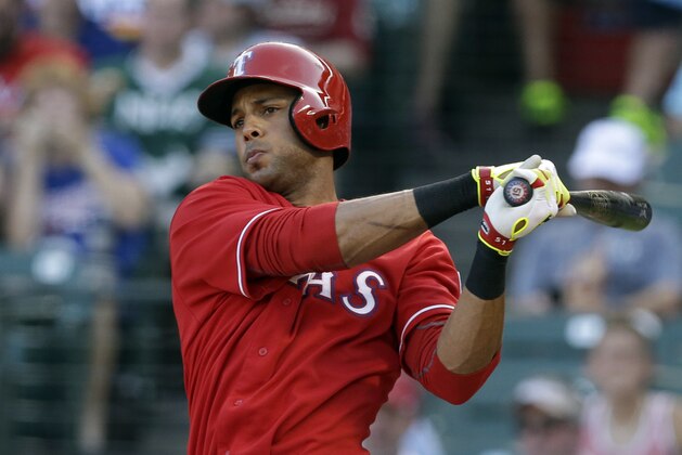 Texas Rangers' Alex Rios follows through on a double to left off a pitch from Houston Astros' Dallas Keuchel in the first inning of a baseball game, Wednesday, July 9, 2014, in Arlington, Texas. (AP Photo/Tony Gutierrez)