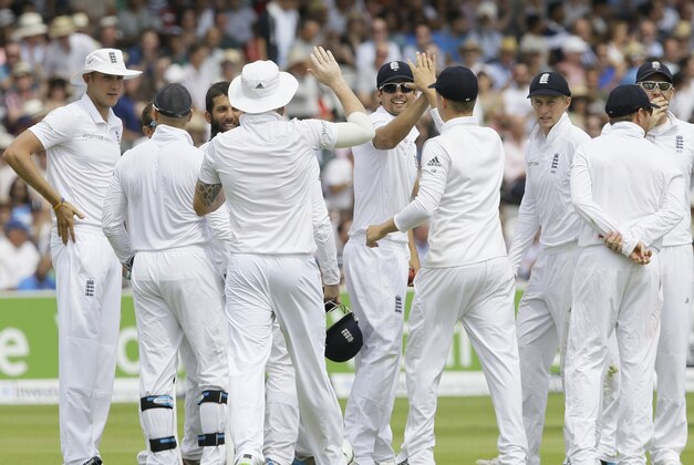 England's captain Alastair Cook, center, celebrates with his team after he catches out India's Stuart Binny for zero during the fourth day of the second test match between England and India at Lord's cricket ground in London, Sunday, July 20, 2014. (AP Photo/Kirsty Wigglesworth)