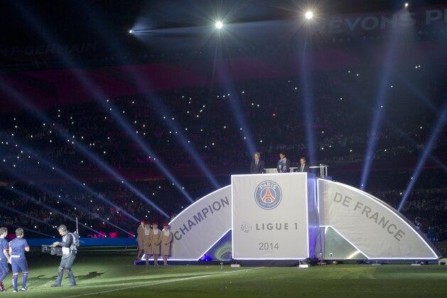 Paris Saint Germain's Brazilian defender Thiago Silva, left,   arrives on the stage during his trophy's ceremony as he celebrates PSG's French League One title, at the Parc des Princes Stadium, in Paris, Saturday, May. 17, 2014.(AP Photo/Jacques Brinon)