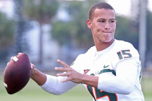 Miami quarterbacks Stephen Morris (17) and Kevin Olsen (19) celebrate after a Miami TD during the first half of a NCAA college football game  against Florida in Miami Gardens, Fla., Saturday, Sept. 7, 2013. (AP Photo/J Pat Carter)