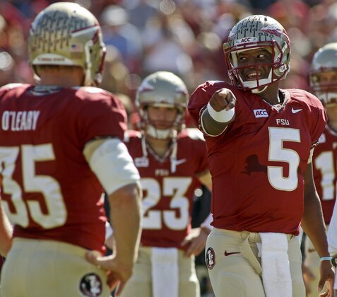 Florida State quarterback Jameis Winston (5) smiles as he points to tight end Nick O'Leary (35) before the start of an NCAA college football game against North Carolina State on Saturday, Oct. 26, 2013, in Tallahassee, Fla. Florida State beat North Carolina State 49-17. (AP Photo/Phil Sears)