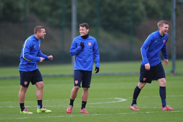 ST ALBANS, ENGLAND - FEBRUARY 18:  Per Mertesacker, Mesut Ozil and Lukas Podolski of Arsenal warm up during a training session at London Colney on February 18, 2014 in St Albans, England.  (Photo by Shaun Botterill/Getty Images)