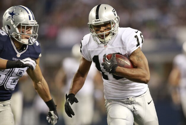 Nov 28, 2013; Arlington, TX, USA; Oakland Raiders wide receiver Andre Holmes (18) runs after catching a pass against the Dallas Cowboys during a NFL football game on Thanksgiving at AT&T Stadium. Dallas beat Oakland 31-24. Mandatory Credit: Tim Heitman-USA TODAY Sports