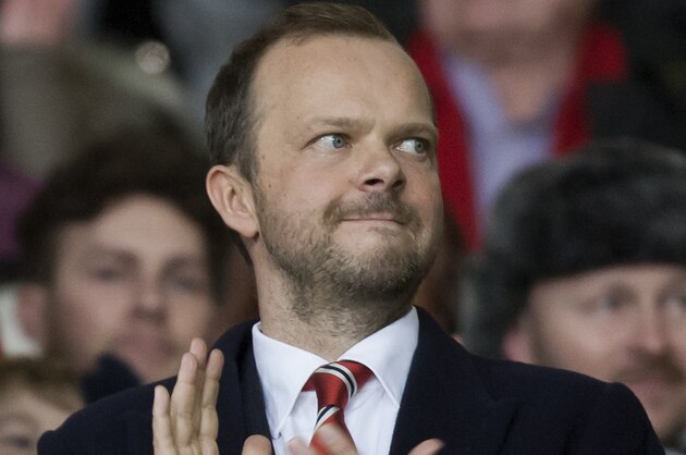 Manchester United chief executive Ed Woodward applauds before the team's English Premier League soccer match against Tottenham at Old Trafford Stadium, Manchester, England, Wednesday Jan. 1, 2014. (AP Photo/Jon Super)