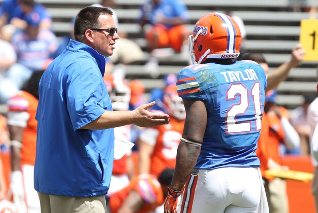 April 6, 2013; Gainesville FL, USA; Florida Gators running back coach  Brain White talks with running back Kelvin Taylor (21) during the spring practice for the Orange and Blue Deput at Ben Hill Griffin Stadium. Mandatory Credit: Kim Klement-USA TODAY Sports