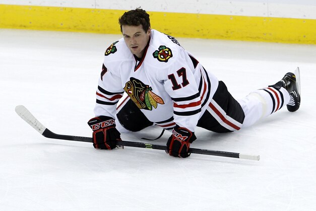 Chicago Blackhawks defenseman Sheldon Brookbank (17) stretches prior to an NHL hockey game against the Minnesota Wild in St. Paul, Minn., Thursday, Dec. 5, 2013. (AP Photo/Ann Heisenfelt)
