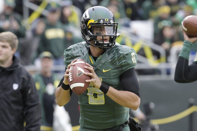 Oregon quarterback Marcus Mariota is shown warming up for an NCAA college football game against UCLA in Eugene, Ore., Saturday, Oct. 26, 2013. (AP Photo/Don Ryan)