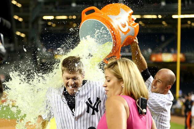 NEW YORK, NY - JULY 23:  Chase Headley #12 of the New York Yankees gets a gatorade bath by teammate Brett Gardner #11 after the game against the Texas Rangers on July 23, 2014 at Yankee Stadium in the Bronx borough of New York City.The New York Yankees defeated the Texas Rangers 2-1 in 14 innings.  (Photo by Elsa/Getty Images)