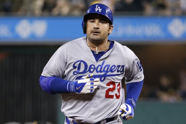 Los Angeles Dodgers' Adrian Gonzalez (23) rounds second after hitting a two run home run off Pittsburgh Pirates relief pitcher Jared Hughes during the seventh inning of a baseball game in Pittsburgh Tuesday, July 22, 2014. The Pirates won 12-7.  (AP Photo)