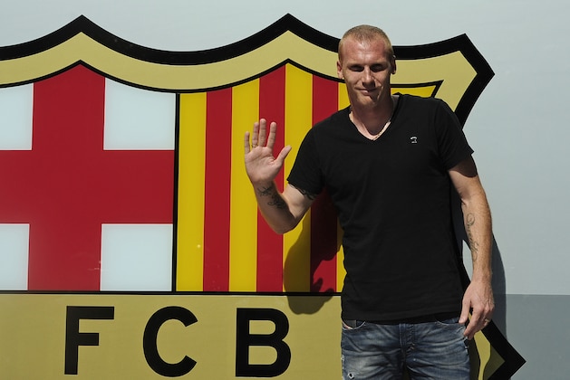 FC Barcelona's new French player Jeremy Mathieu gestures after his arrival at the club's office at the Camp Nou stadium in Barcelona, Spain, Wednesday, July 23, 2014. Barcelona says it has signed France defender Jeremy Mathieu on a four-year contract with an option to extend it for another season. Barcelona says it has paid euro 20 million ($27 million) for the 30-year-old Mathieu, with a buyout clause fixed at euro 50 million. (AP Photo/Manu Fernandez)
