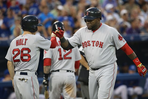 TORONTO, CANADA - JULY 21: David Ortiz #34 of the Boston Red Sox is congratulated by Brock Holt #26 after hitting a two-run home run in the fifth inning during MLB game action against the Toronto Blue Jays on July 21, 2014 at Rogers Centre in Toronto, Ontario, Canada. (Photo by Tom Szczerbowski/Getty Images)