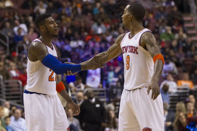 New York Knicks' Iman Shumpert, left, reacts with J.R. Smith, right, during the first half of an NBA basketball game against the Philadelphia 76ers, Saturday, Jan. 11, 2014, in Philadelphia.  The Knicks win 102-92.  (AP Photo/Chris Szagola)