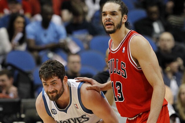 Minnesota Timberwolves forward Kevin Love, left, rubs his right elbow as he is guarded by Chicago Bulls center Joakim Noah during the first quarter of an NBA basketball game in Minneapolis, Wednesday, April 9, 2014. Love said he hyperextended his right elbow in the first half. The Bulls won 102-87. (AP Photo/Ann Heisenfelt)
