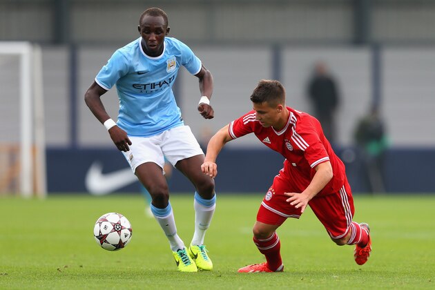 MANCHESTER, ENGLAND - OCTOBER 02:  Seko Fofana of Manchester City battles with Riccardo Basta of FC Bayern Muenchen during the UEFA Youth Champions League match between Manchester City and FC Bayern Muenchen at Ewen Fields on October 2, 2013 in Manchester, England.  (Photo by Julian Finney/Getty Images)