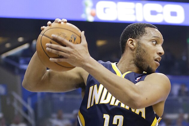 Indiana Pacers' Evan Turner (12) grabs a rebound against the Orlando Magic during the first half of an NBA basketball game in Orlando, Fla., Wednesday, April 16, 2014. (AP Photo/John Raoux)
