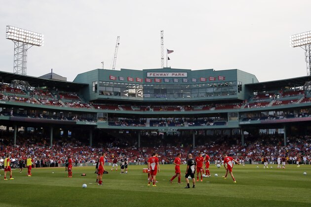 Liverpool FC players warm up prior to a friendly soccer match against AS Roma at Fenway Park in Boston, Wednesday, July 23, 2014. (AP Photo)