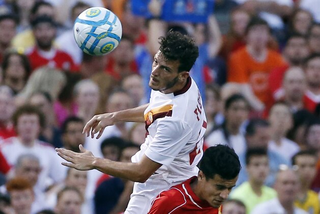 AS Roma midfielder Alessandro Florenzi (24) goes up for the ball against Liverpool FC midfielder Philippe Coutinho, below, during a friendly soccer match at Fenway Park in Boston, Wednesday, July 23, 2014. (AP Photo)